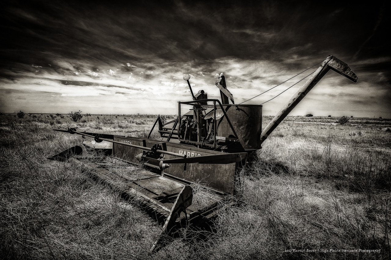 Black and white photo of derelict farm equipment somewhere along Route 66